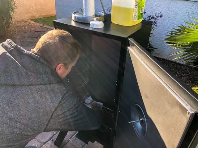 You should give the smoker a quick cleaning before seasoning